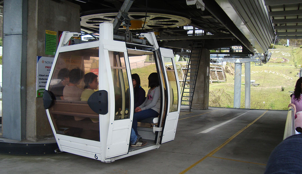 Teleferiqo cable car with people inside, doors about to close before ascending Pichincha Volcano, Quito - Ecuador