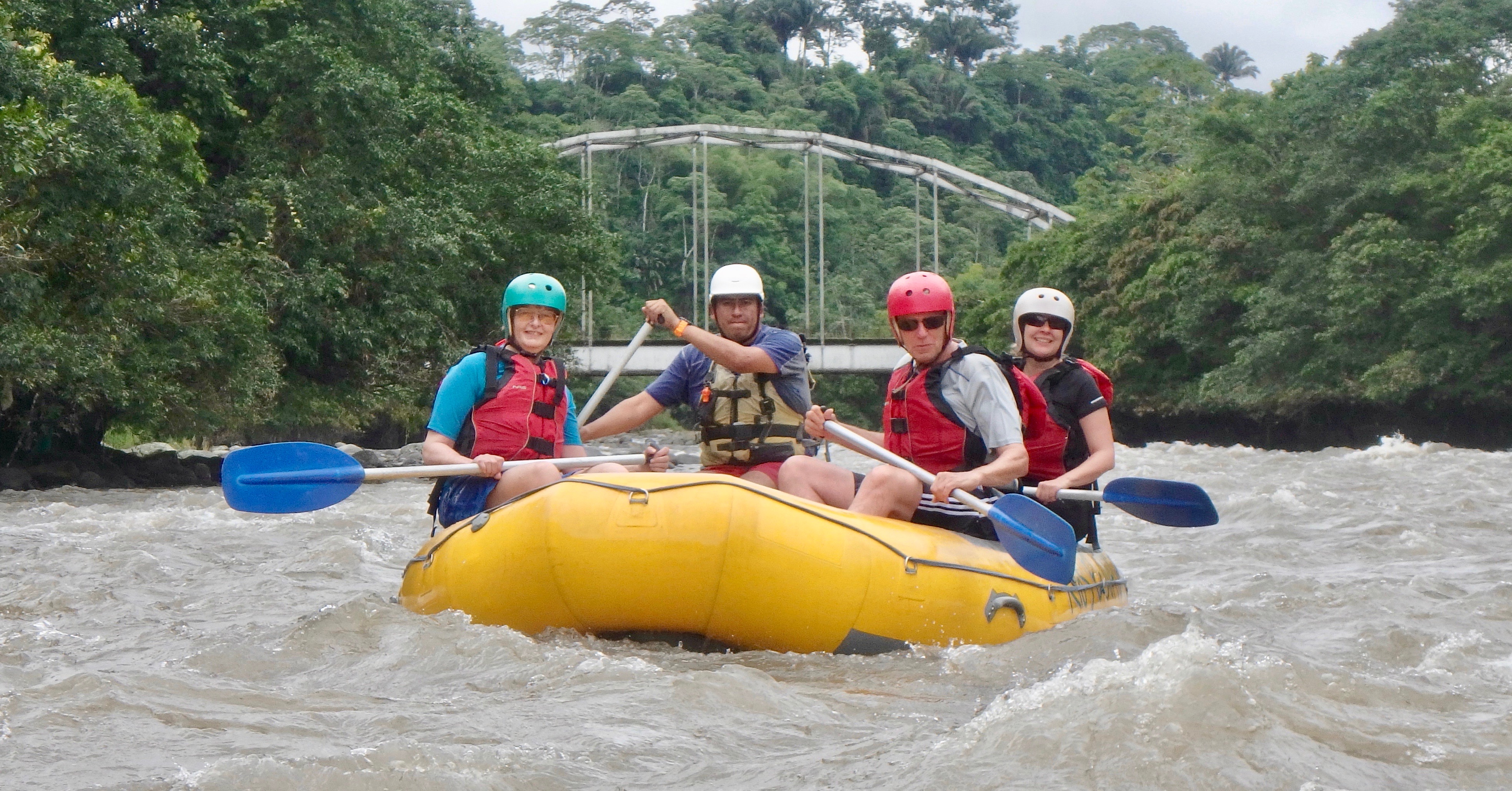 Four Rafters on yellow raft on the Toachi River in Ecuador's Rainforest