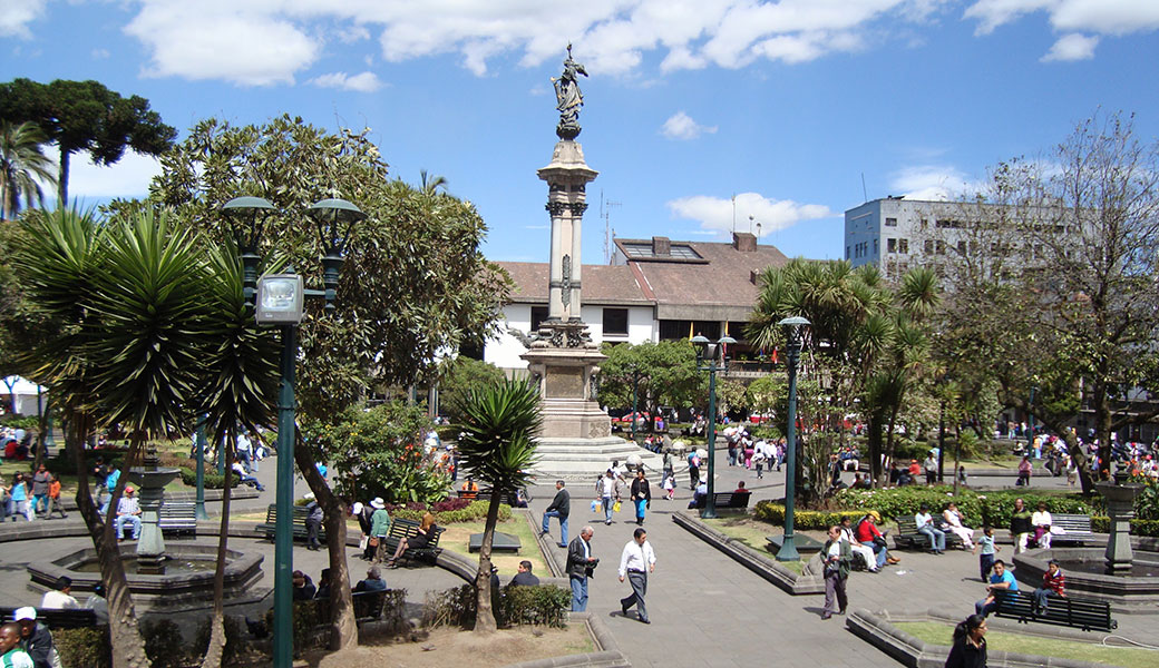 Local people walking around Plaza Grande in Quito Ecuador on a sunny day